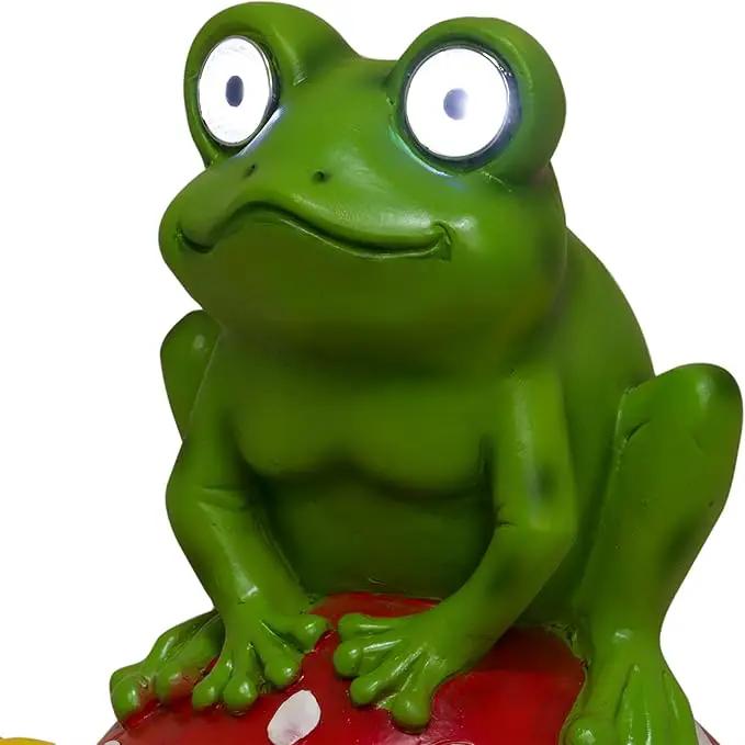 Alpine Corporation ZEN390SLR-S Frog on Mushroom Statue with LED Lights, Solar-Powered LED Frog Garden Statue, 12" H, Green by GreenHaven Gardens