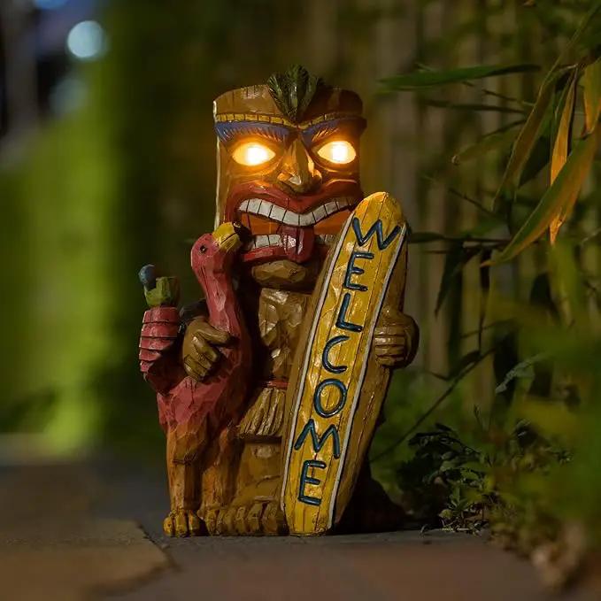 Welcome Tiki Statue with Surfboard Flamingo-Solar Outdoor Decor - Tiki Man with Automatic Switch On Flickering Eyes LED Light for Tiki Bar Decorations, Patio, Balcony, Yard,Lawn,Gifts by GreenHaven Gardens