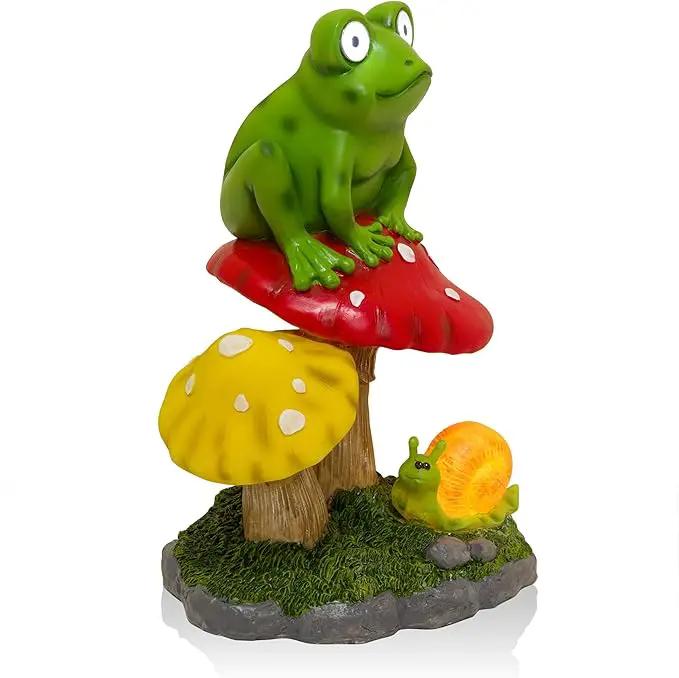 Alpine Corporation ZEN390SLR-S Frog on Mushroom Statue with LED Lights, Solar-Powered LED Frog Garden Statue, 12" H, Green by GreenHaven Gardens