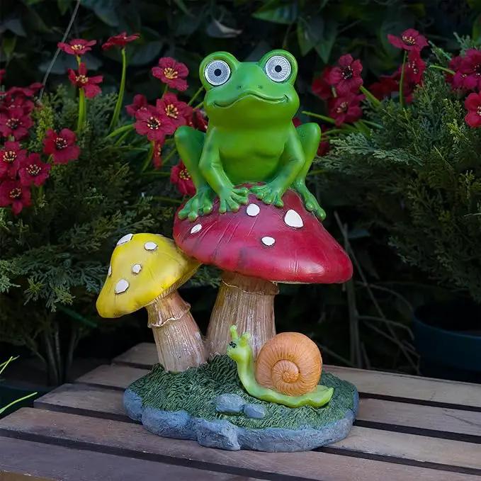 Alpine Corporation ZEN390SLR-S Frog on Mushroom Statue with LED Lights, Solar-Powered LED Frog Garden Statue, 12" H, Green by GreenHaven Gardens