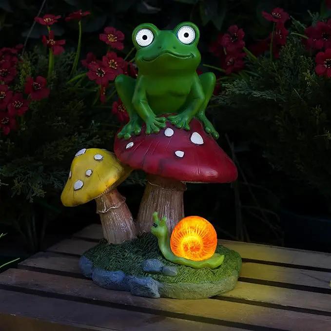 Alpine Corporation ZEN390SLR-S Frog on Mushroom Statue with LED Lights, Solar-Powered LED Frog Garden Statue, 12" H, Green by GreenHaven Gardens