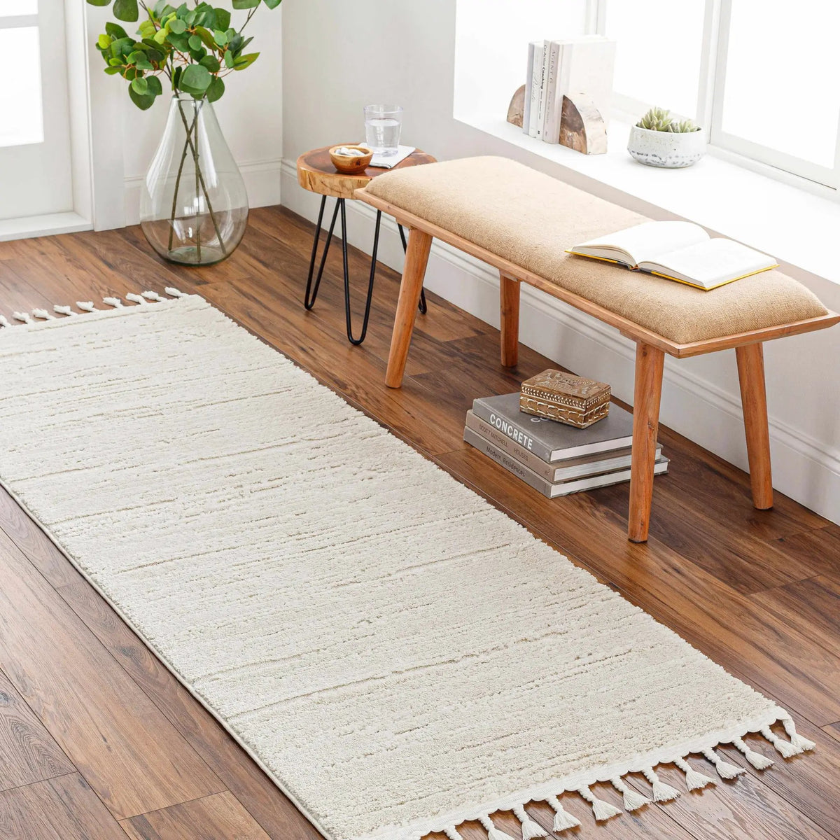 Ibarra Textured Ivory High/Low Pile Rug with Tassels, installed in a room