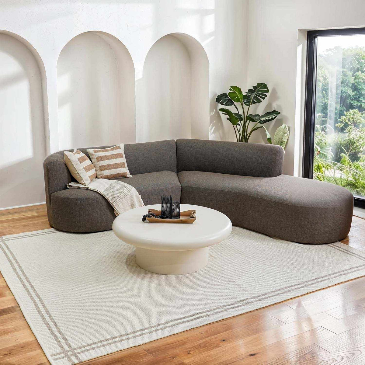 Nimue Taupe Area Rug - Clearance, installed in a room