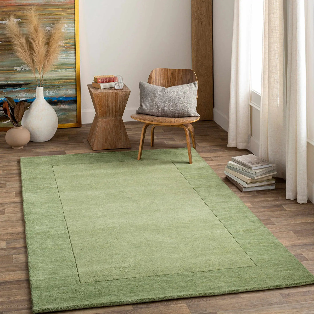Bordered Solid Green Wool Rug, installed in a room