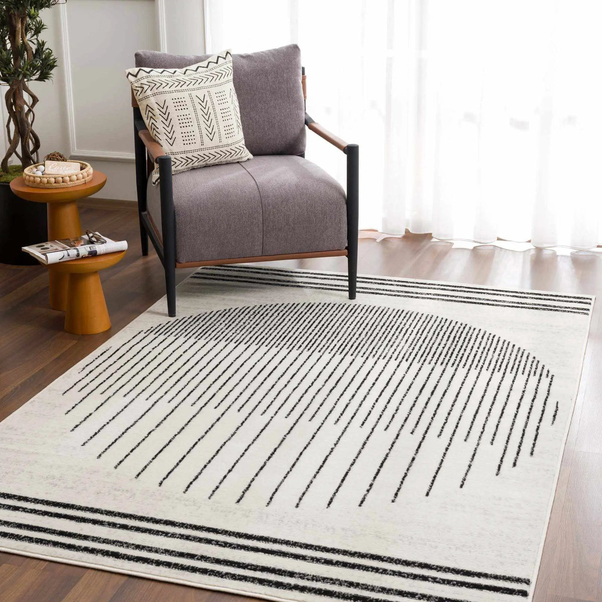 Angus Abstract Black and White Area Rug, installed in a room