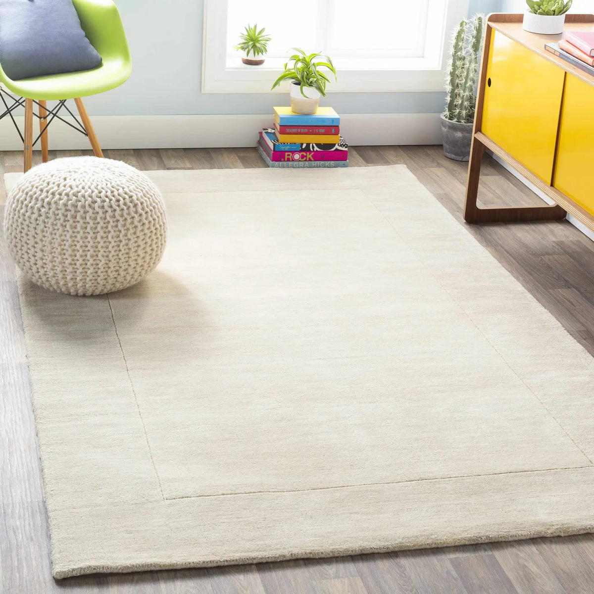 Bordered Solid Beige Cream Wool Rug, installed in a room