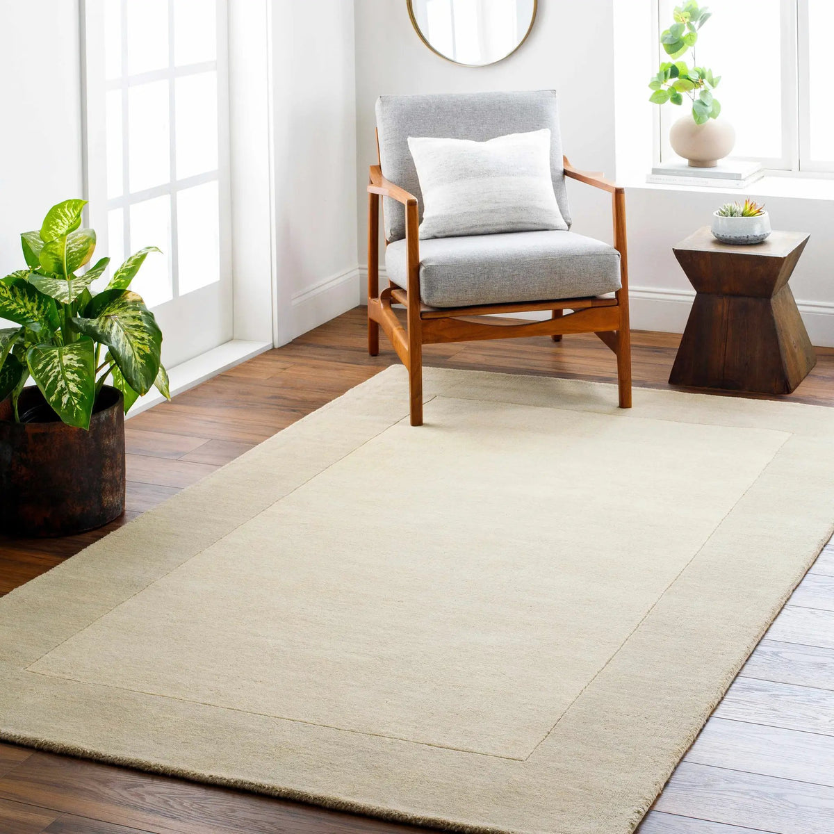 Bordered Solid Beige Cream Wool Rug, installed in a room 2