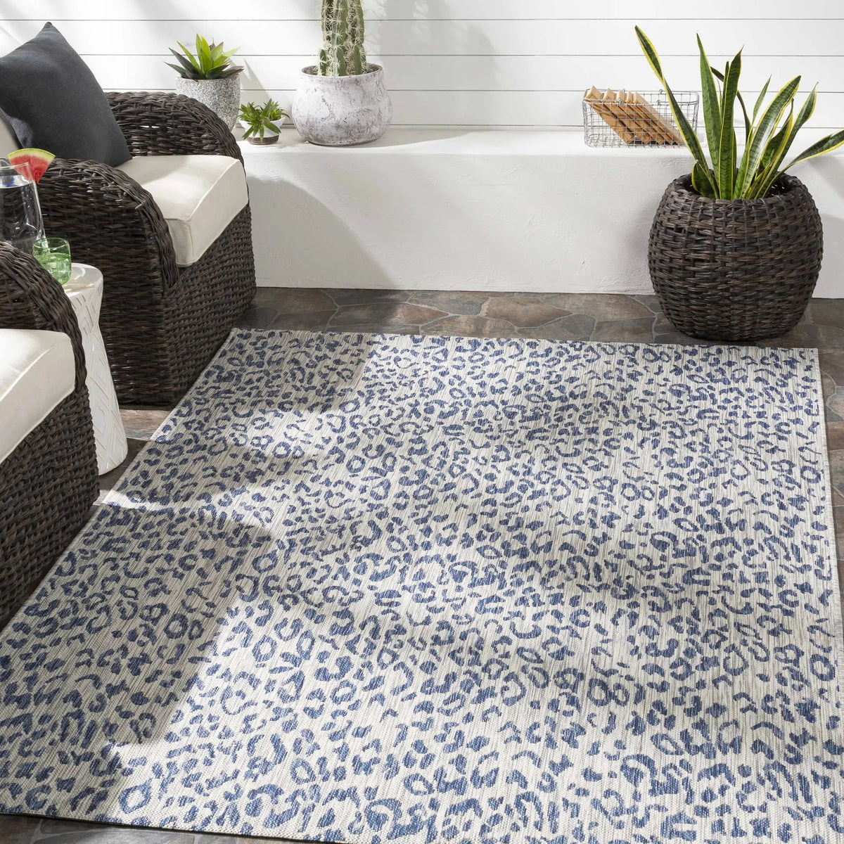 Skipsea Blue Leopard Performance Outdoor Rug, installed in a room