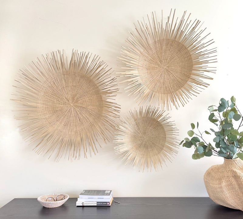Natural Sunburst Plate Wall Hanging - 23", installed in a room