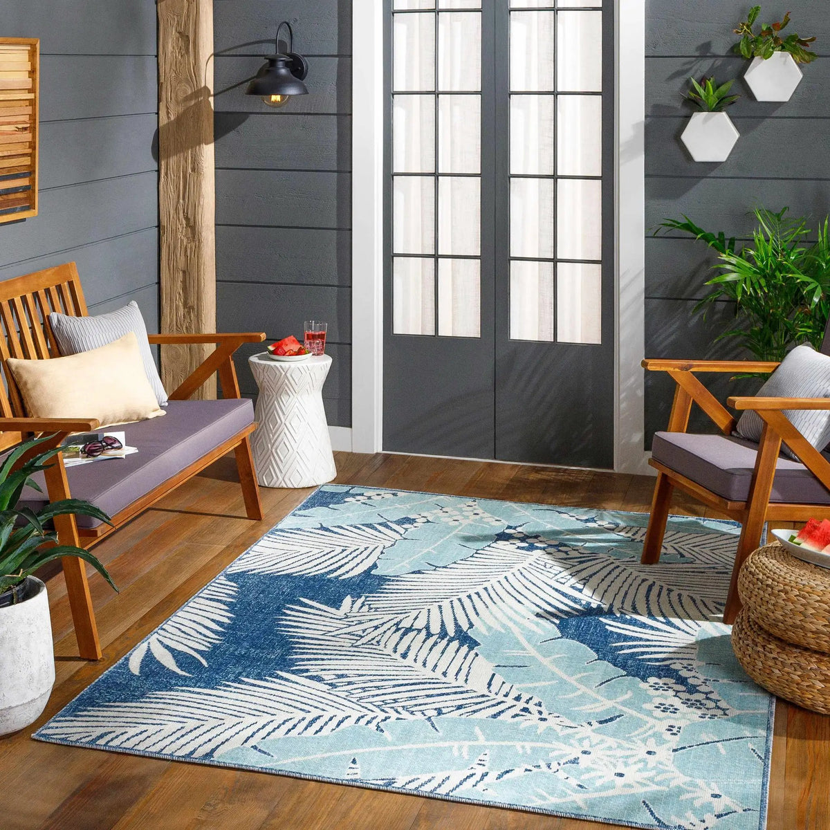 Thebarton Coastal Blue Palm Outdoor Area Rug, installed in a room