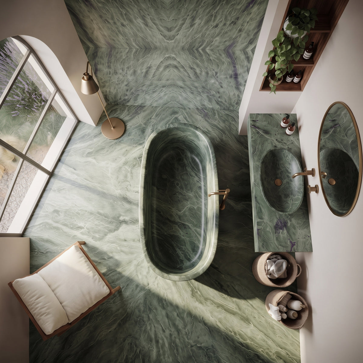 An overhead view of a luxury bathroom featuring a freestanding oval bathtub and matching marble vanity with a sink, set in a room with green marble walls and floor, brass fixtures, and a window with an arched frame.