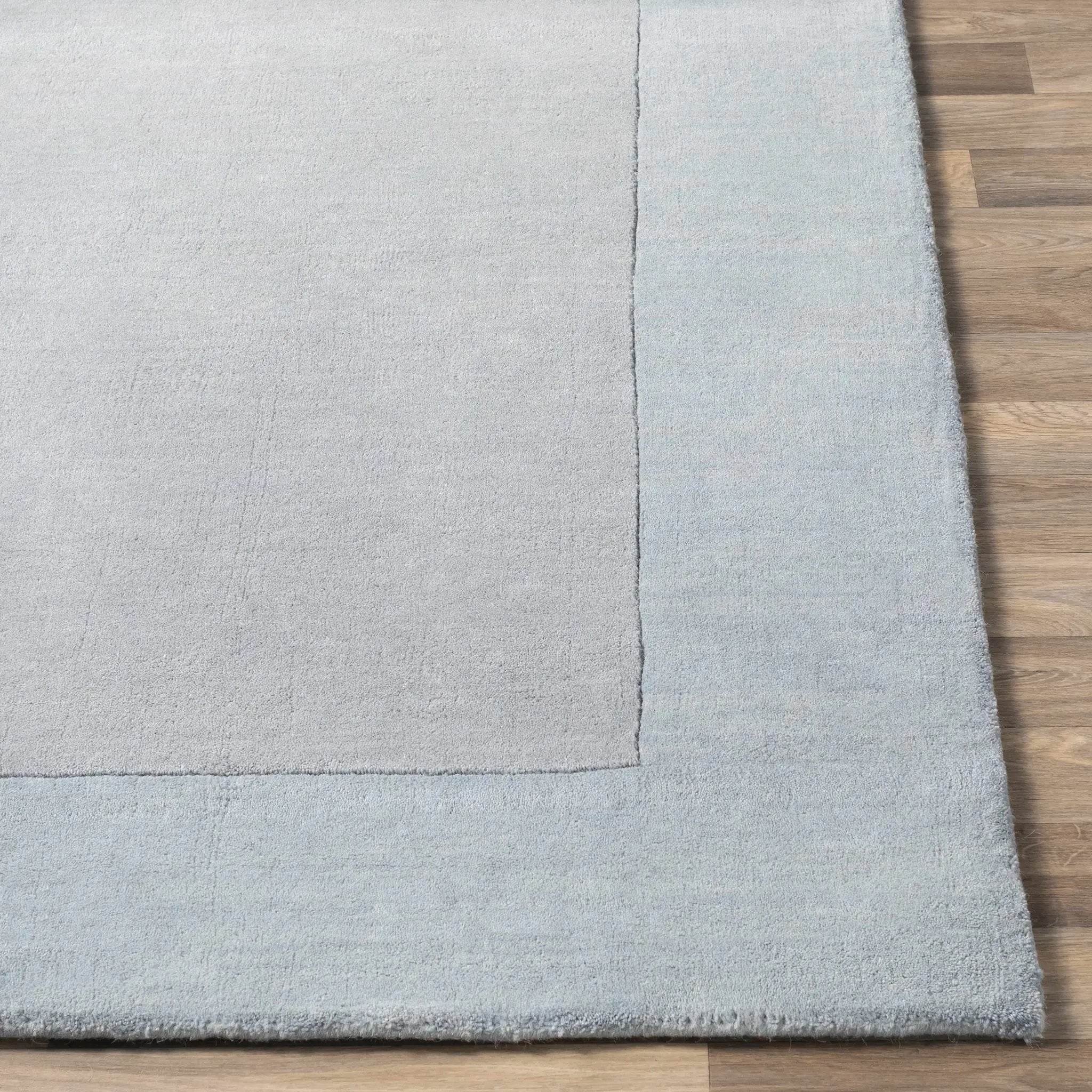 Arkabutla Solid Blue Bordered Wool Rug by Boutique Rugs