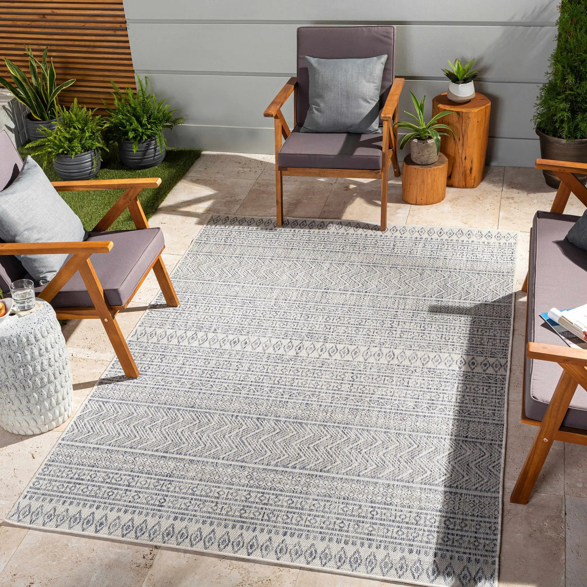 Madras Navy All Over Performance Outdoor Rug, installed in a room