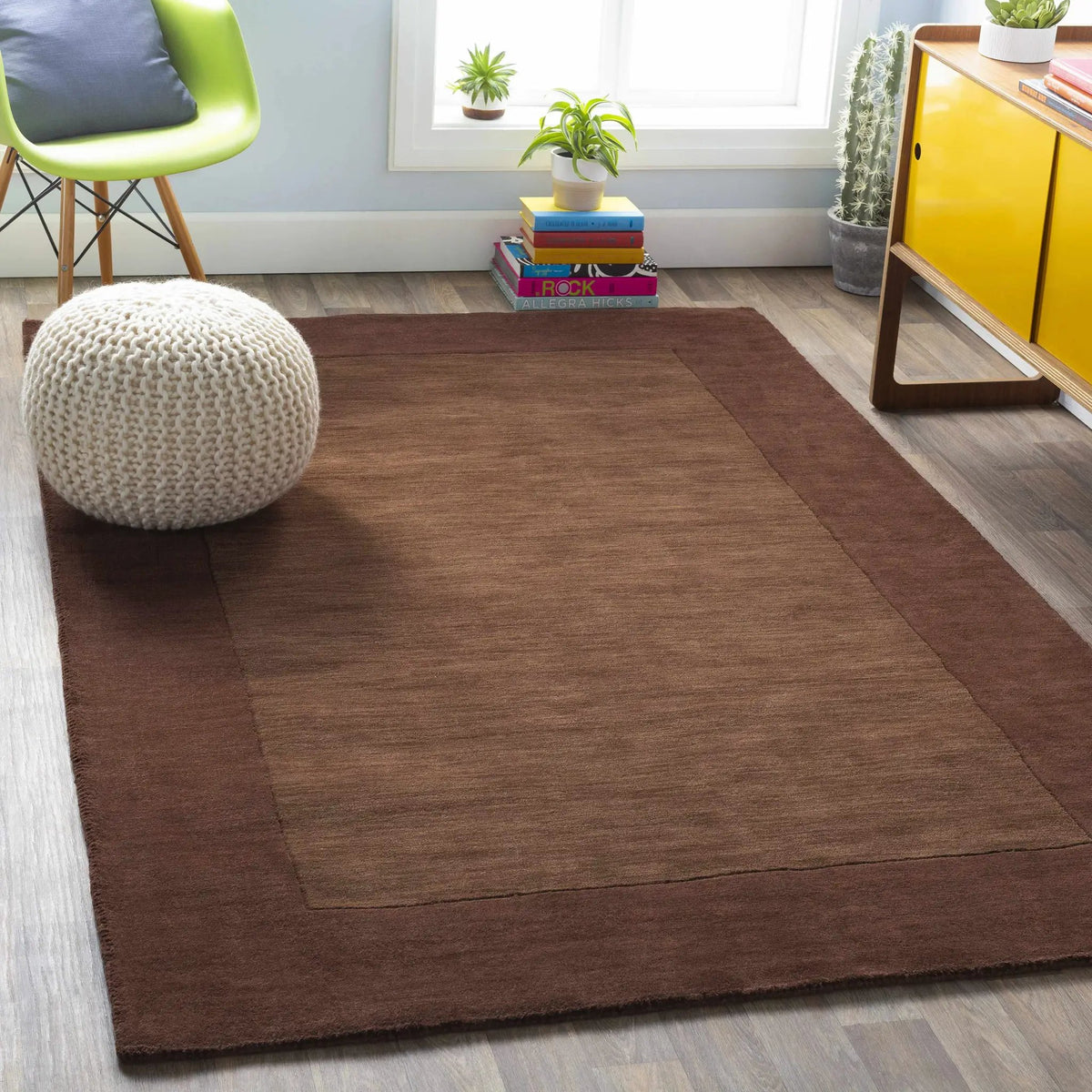 Bordered Solid Brown Wool Rug, installed in a room