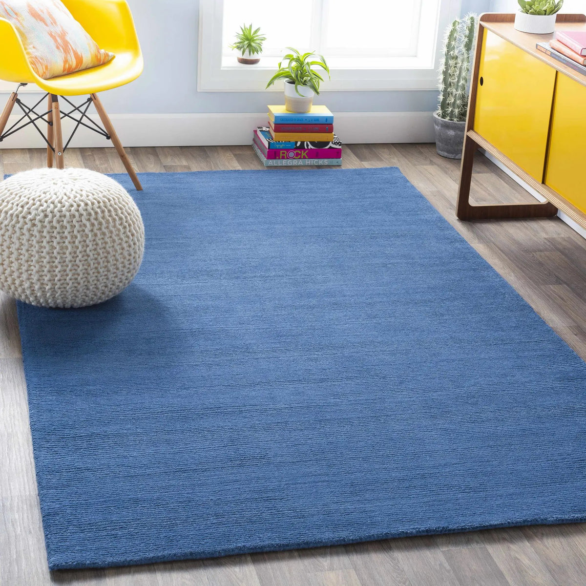 Brockton Solid Blue Wool Rug, installed in a room