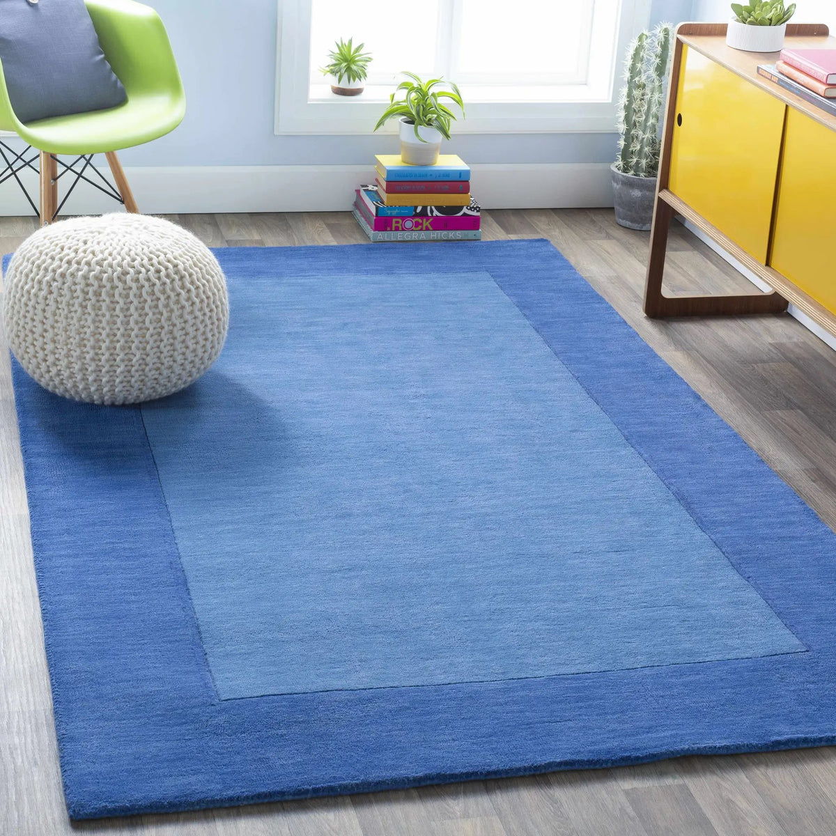 Macedon Blue Bordered Wool Rug, installed in a room