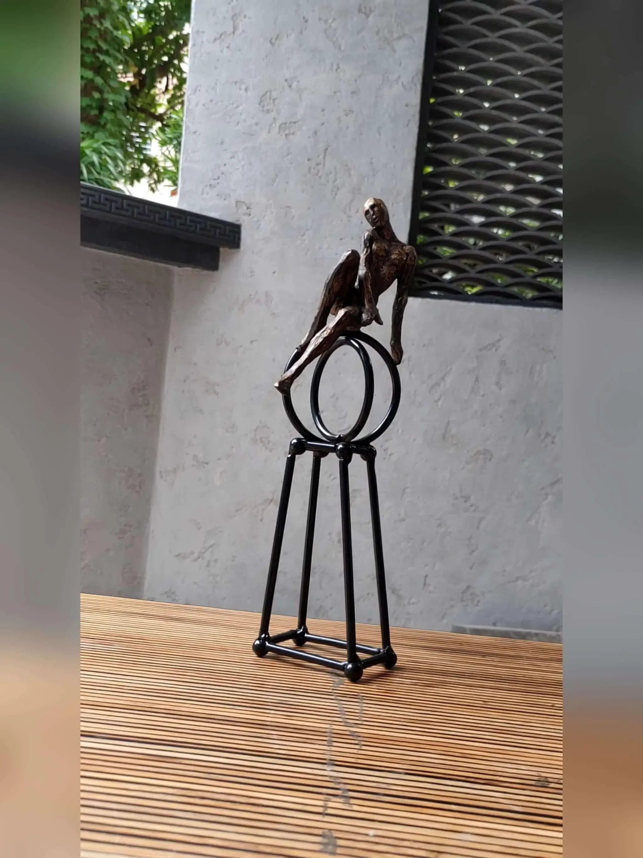 Abstract Seated Figure Sculpture on Geometric Stand – Modern Iron Table Decor by House Of Avana