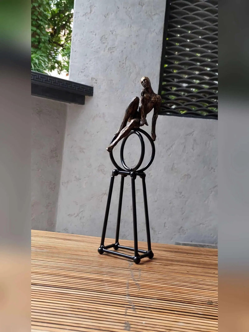 Abstract Seated Figure Sculpture on Geometric Stand – Modern Iron Table Decor by House Of Avana