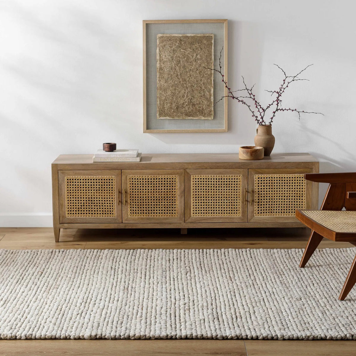 Olisa Cream Wool Area Rug, installed in a room