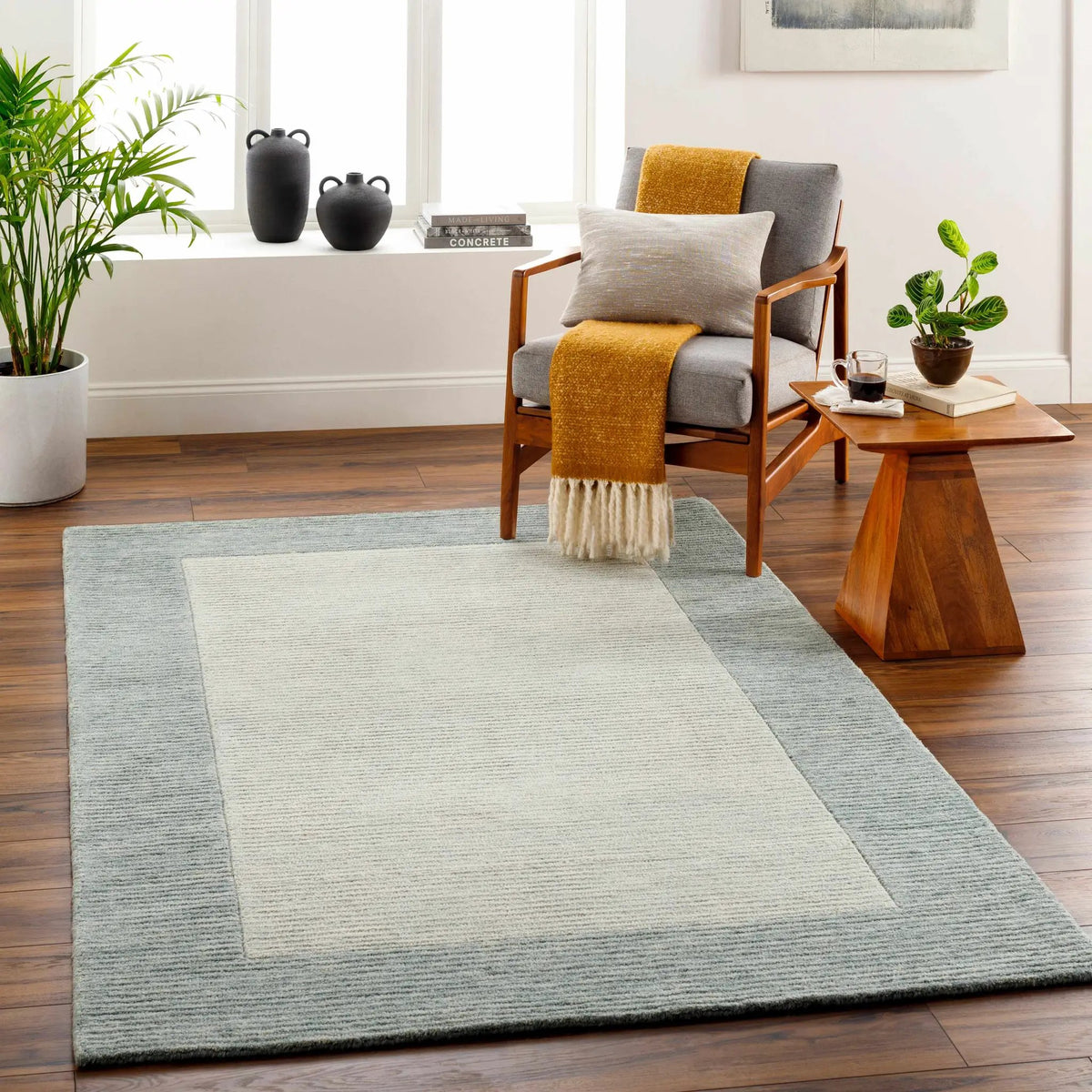 Amadi Green Wool Area Rug, installed in a room