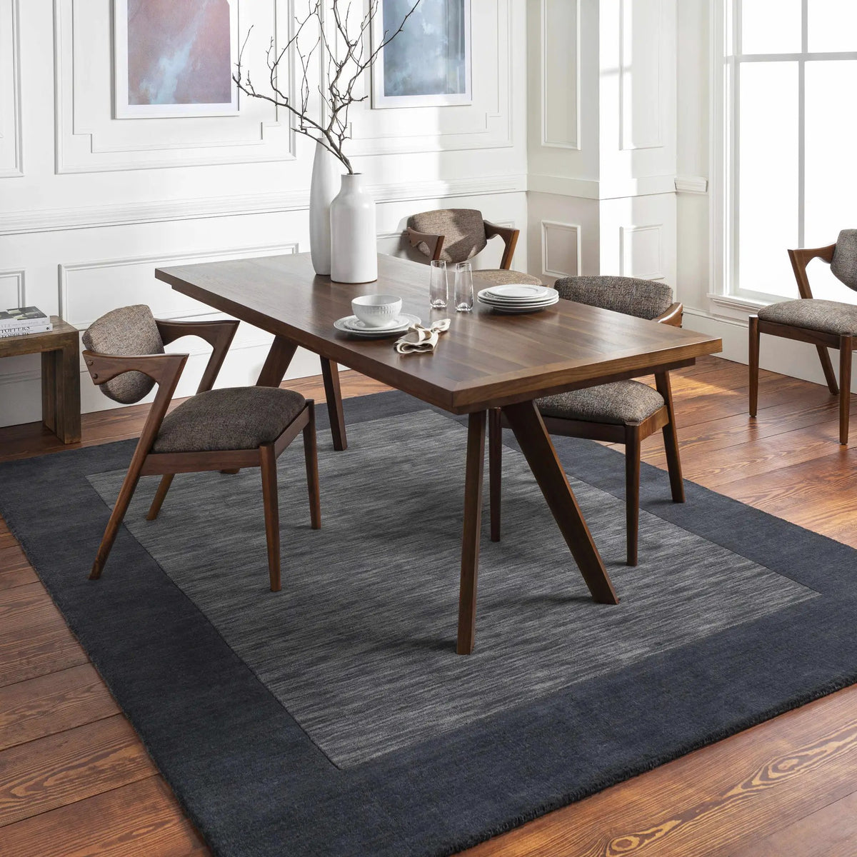 Bordered Solid Black Charcoal Wool Rug, installed in a room