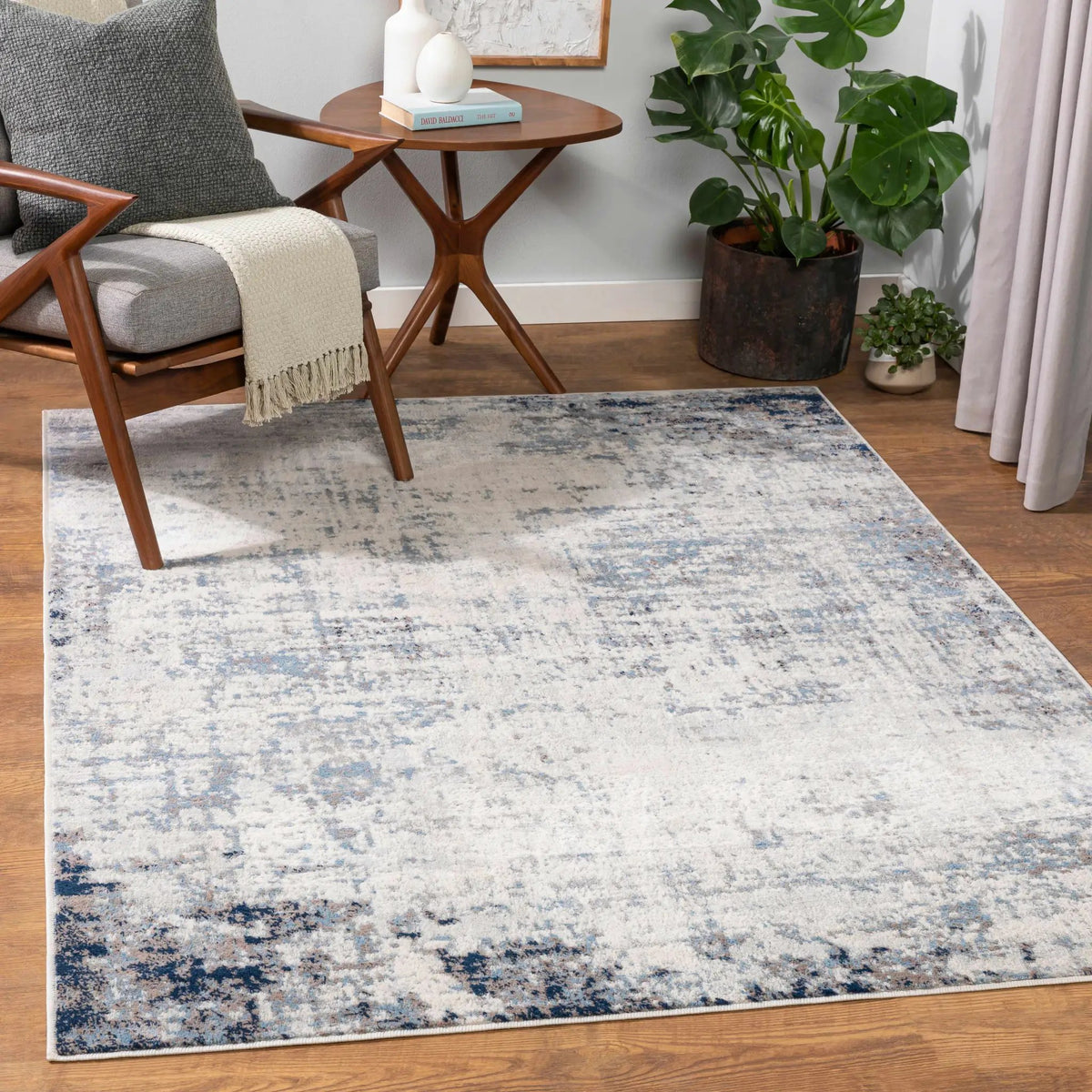 Texanna Abstract Blue/Gray Area Rug, installed in a room